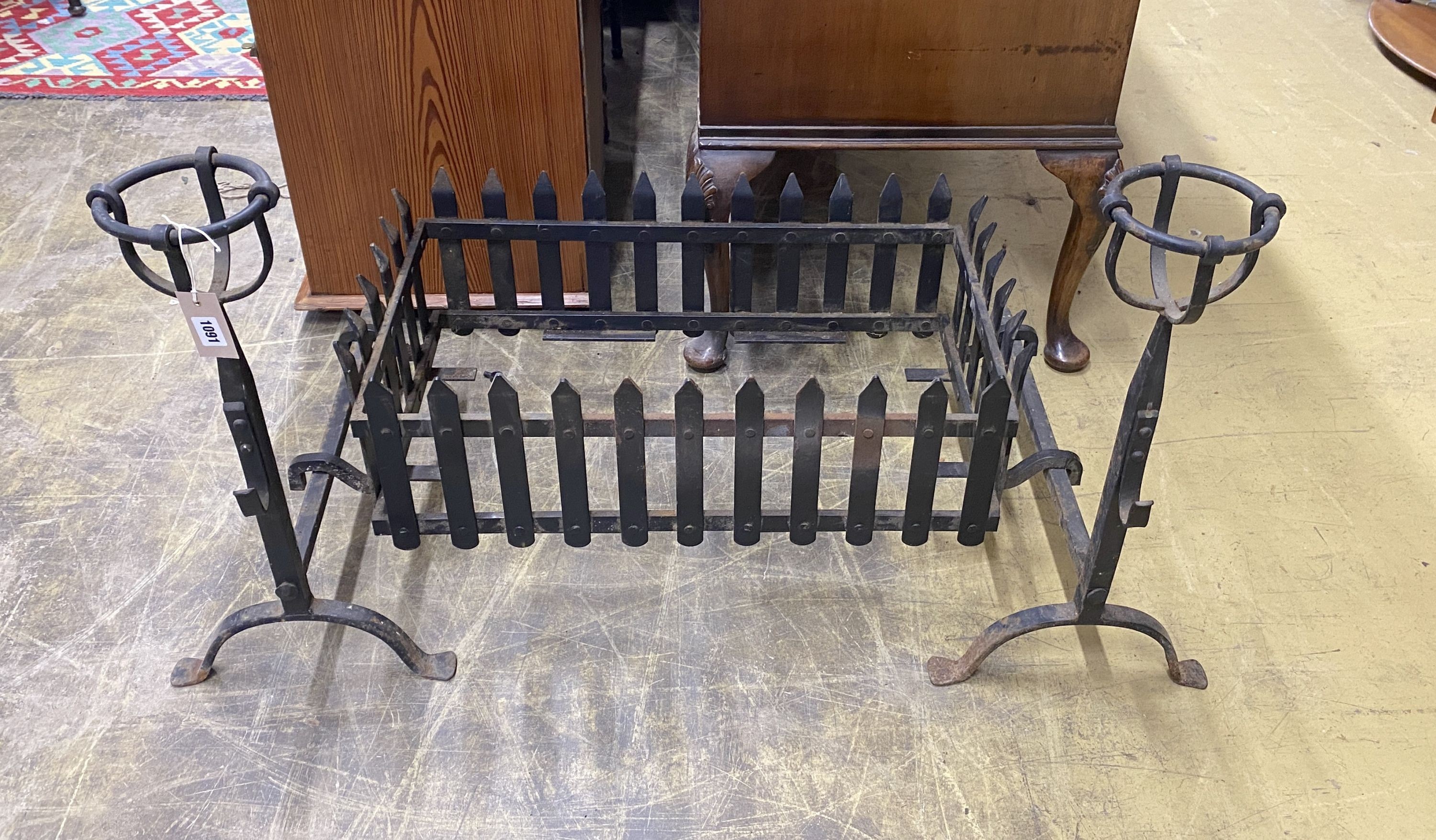 A wrought iron fire basket, width 71cm, depth 41cm, height 36cm and a pair of fire dogs